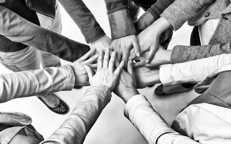 A group of people with their hands in the air.