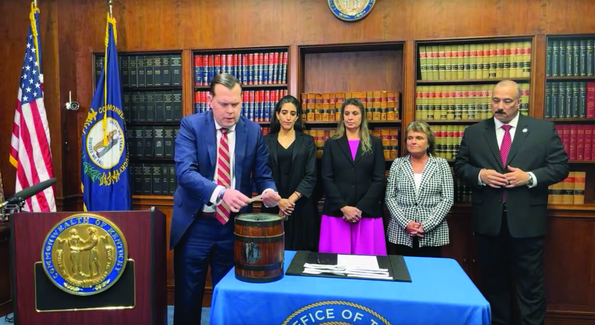 	Attorney General Russell Coleman draws the names of 12 counties randomly selected for post-election inquiry on Nov. 20 in the Kentucky Capitol as members of his staff witness the public drawing. Photo: YouTube screenshot